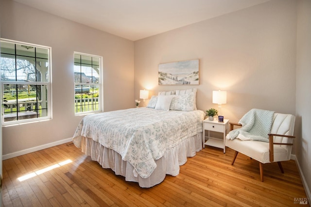 bedroom with baseboards and light wood finished floors