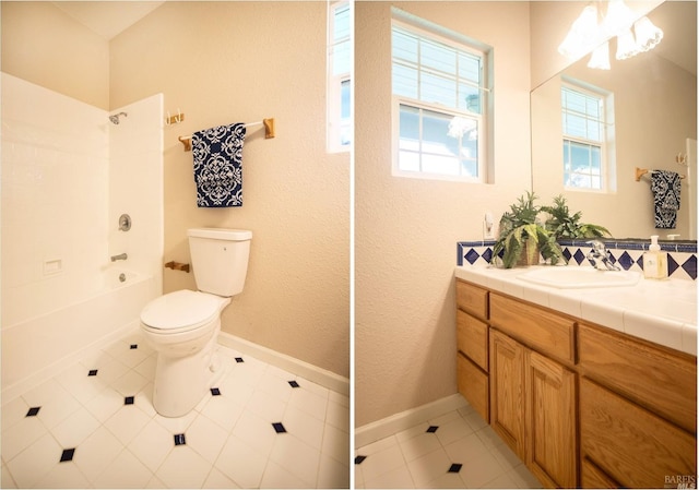 bathroom featuring baseboards, toilet, shower / bathtub combination, tile patterned floors, and vanity