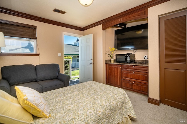 bedroom with visible vents, multiple windows, light colored carpet, and ornamental molding