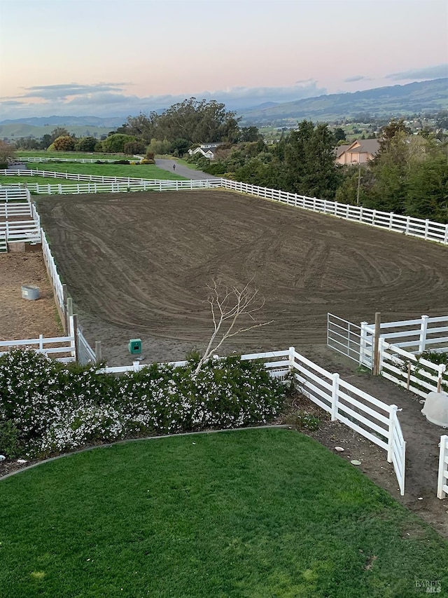 view of yard with an enclosed area and a rural view