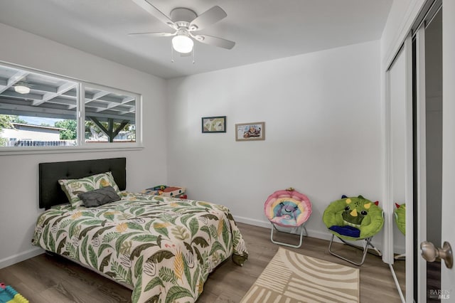 bedroom with hardwood / wood-style floors, a closet, and ceiling fan