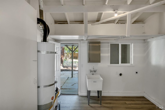 laundry room with strapped water heater, dark wood-type flooring, and hookup for an electric dryer