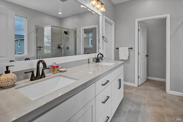 bathroom featuring tile patterned floors, an enclosed shower, and vanity