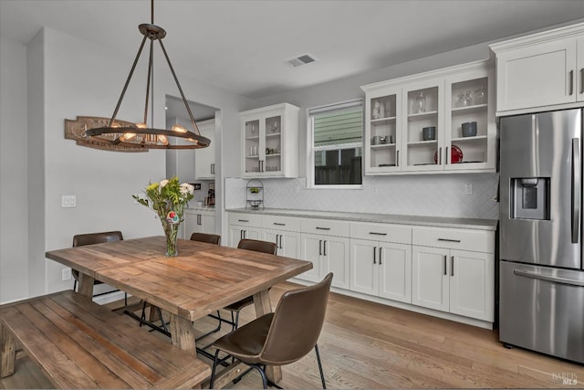 dining room with a chandelier and light hardwood / wood-style floors