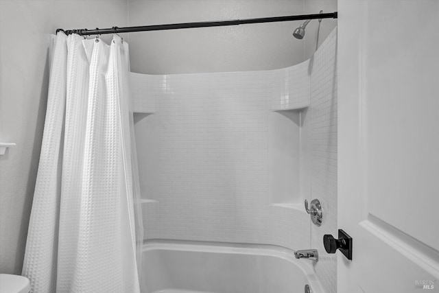 bathroom with shower / bathtub combination with curtain