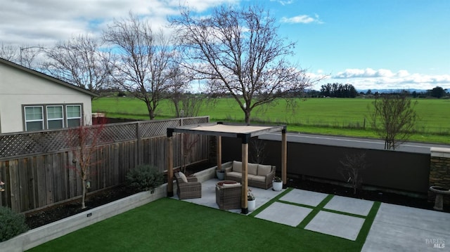 view of yard featuring a patio, an outdoor hangout area, and a rural view