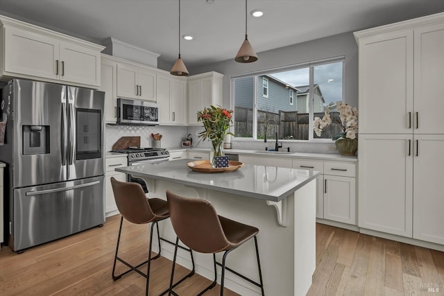 kitchen with white cabinetry, sink, and stainless steel appliances