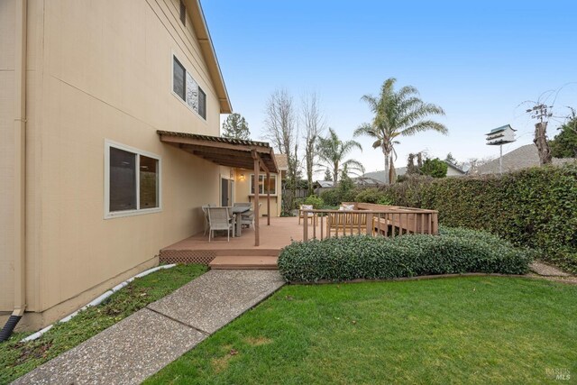 view of yard with a deck and a pergola