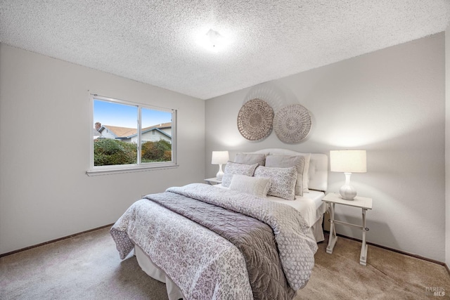 bedroom featuring light colored carpet and a textured ceiling