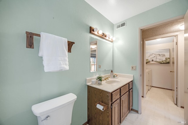 bathroom featuring vanity and toilet