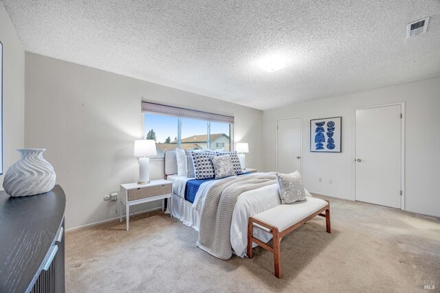 carpeted bedroom featuring a textured ceiling