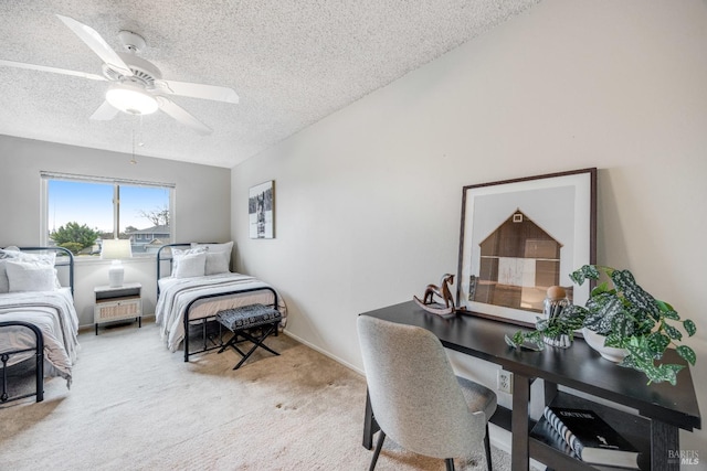 carpeted bedroom with ceiling fan and a textured ceiling