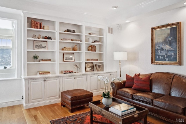 living room featuring light wood-style flooring and visible vents