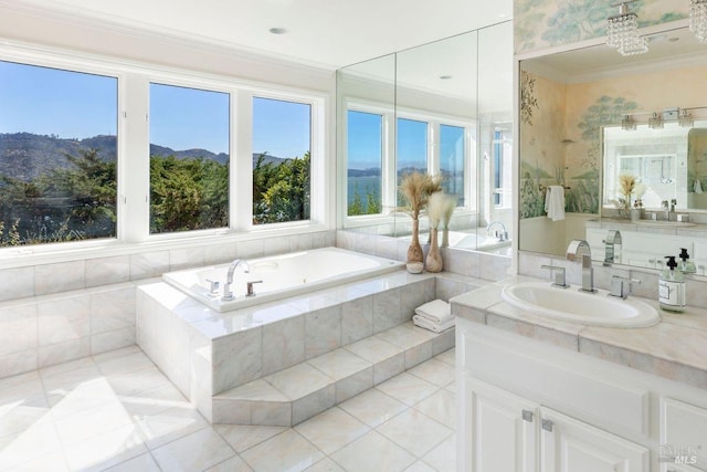 bathroom featuring crown molding, vanity, a mountain view, a relaxing tiled tub, and tile patterned flooring