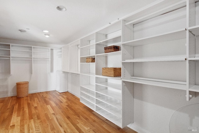 spacious closet with wood finished floors