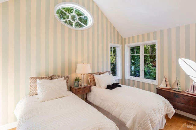 bedroom with hardwood / wood-style flooring and vaulted ceiling