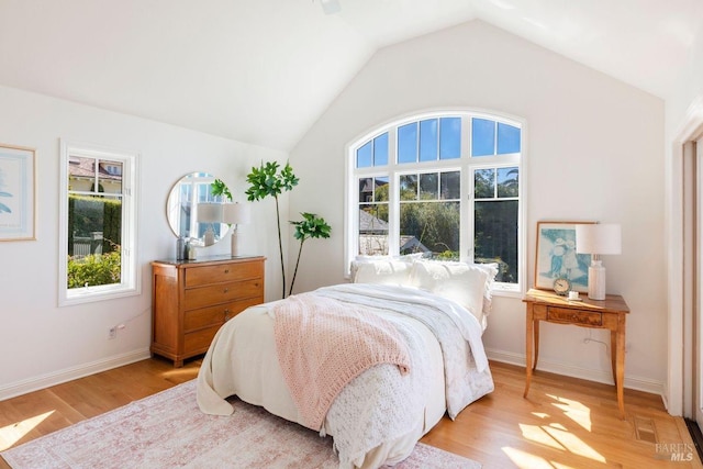 bedroom featuring light hardwood / wood-style flooring and vaulted ceiling