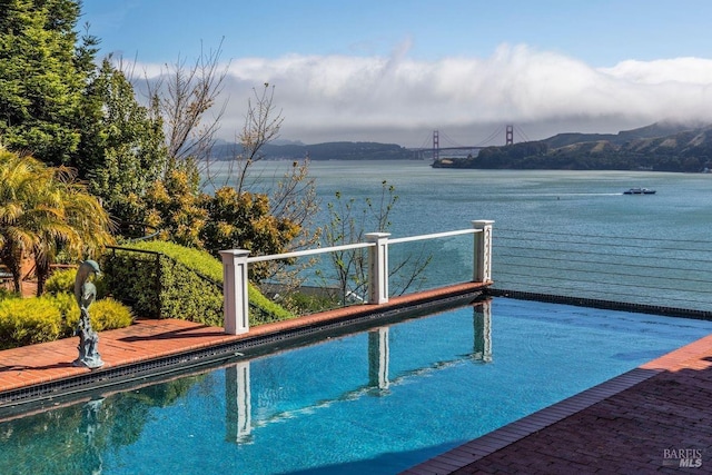 view of pool with a water and mountain view