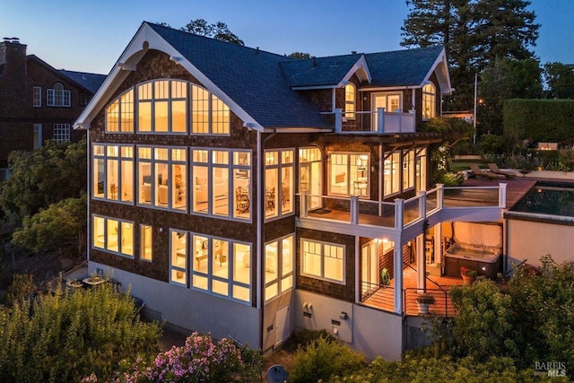 rear view of house featuring a balcony and crawl space