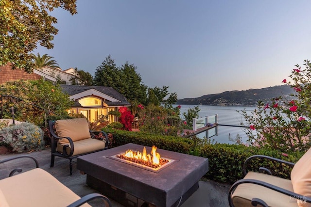 view of patio featuring a fire pit and a water and mountain view