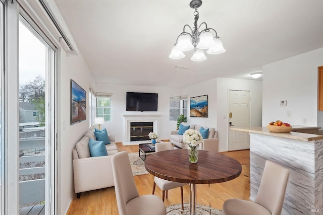 dining space featuring a notable chandelier and light hardwood / wood-style flooring