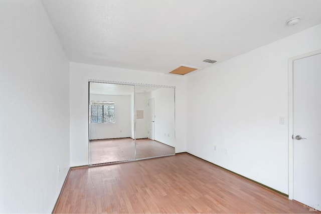 empty room with light hardwood / wood-style flooring