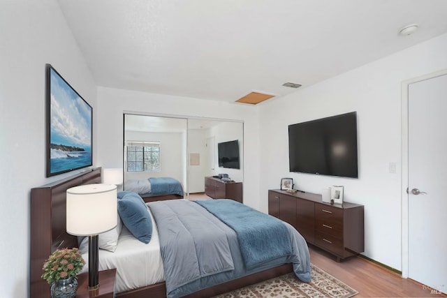 bedroom featuring light hardwood / wood-style floors and a closet