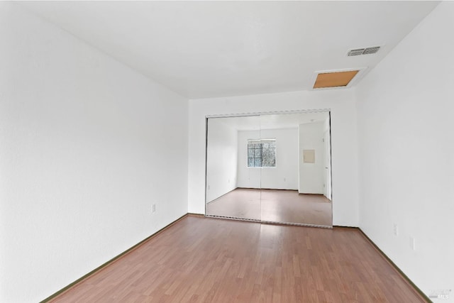 spare room featuring hardwood / wood-style flooring