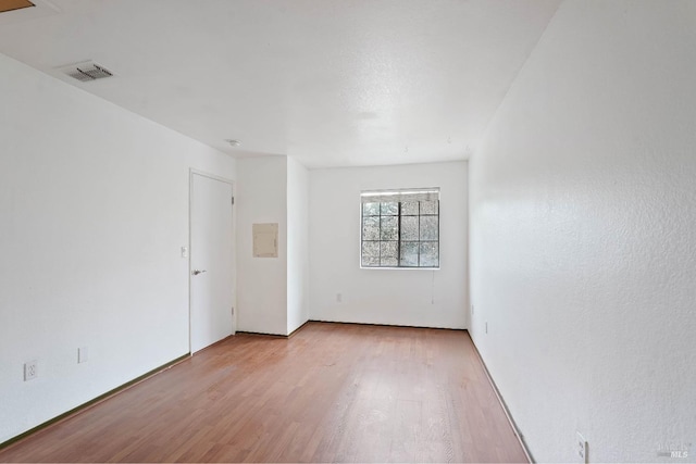 empty room with light hardwood / wood-style flooring