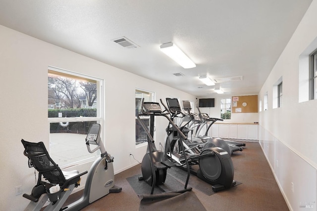 exercise room featuring a textured ceiling