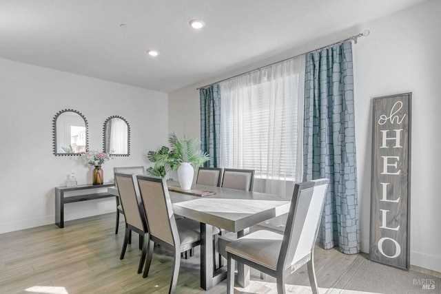 dining area with light hardwood / wood-style floors