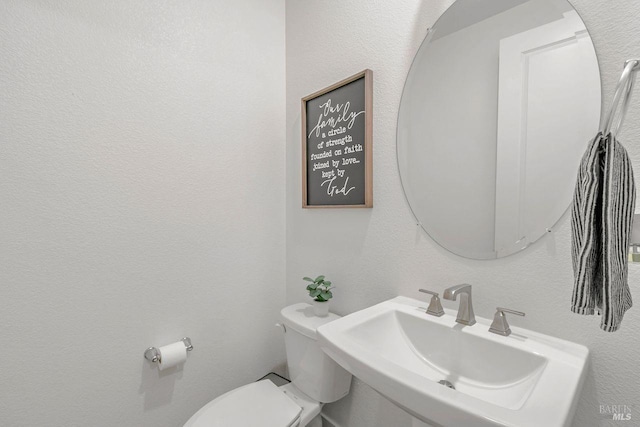 bathroom with toilet and sink