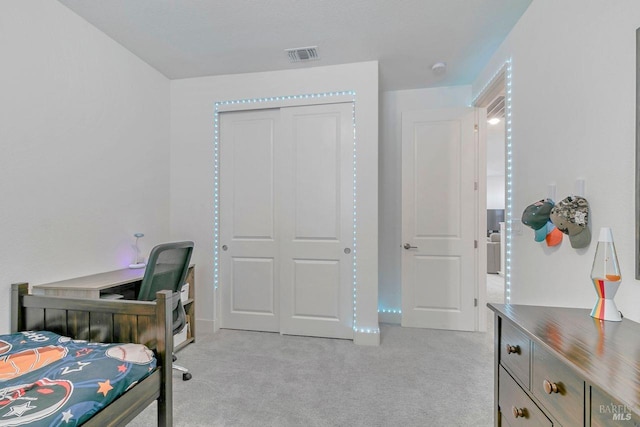 carpeted bedroom with a closet