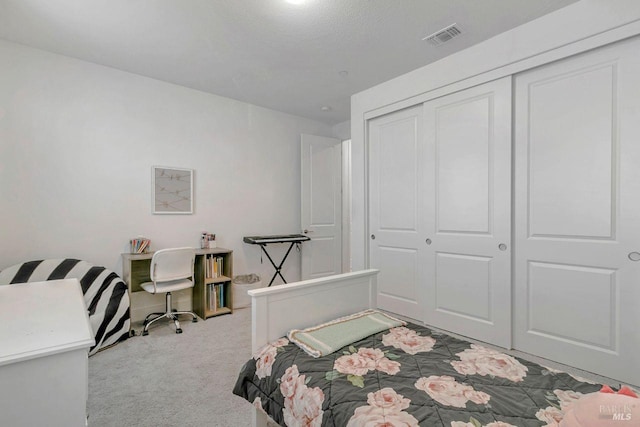 carpeted bedroom featuring a closet