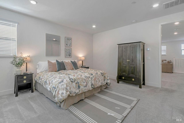 bedroom featuring light colored carpet