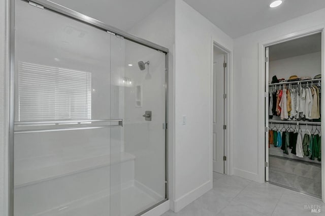 bathroom featuring an enclosed shower and tile patterned flooring