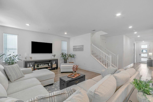 living room with a healthy amount of sunlight and light hardwood / wood-style flooring