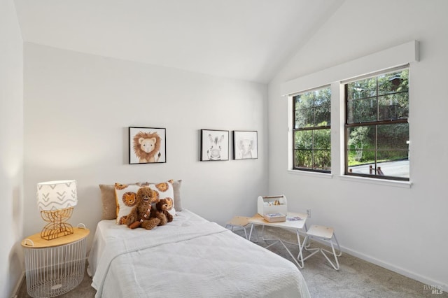 carpeted bedroom with lofted ceiling