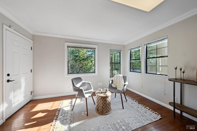 sitting room with crown molding and hardwood / wood-style floors