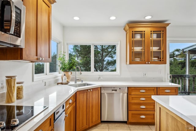 kitchen featuring sink, stainless steel appliances, and light tile patterned flooring