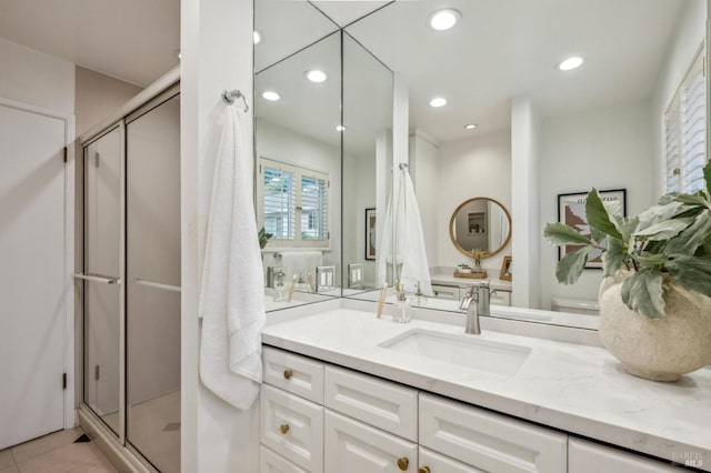 bathroom with vanity, tile patterned floors, and a shower with door