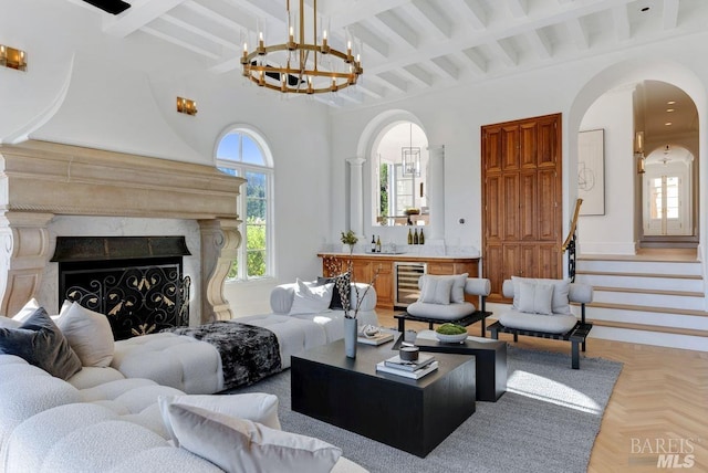 living room featuring parquet floors, a fireplace, wine cooler, and beamed ceiling
