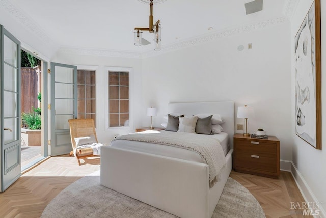 bedroom featuring light parquet flooring, ornamental molding, and access to exterior