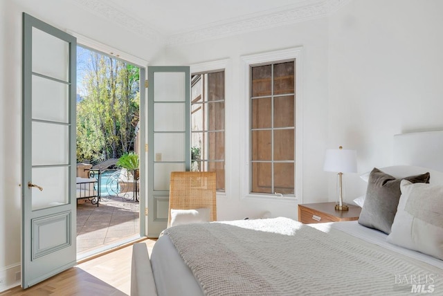 bedroom with crown molding and parquet floors