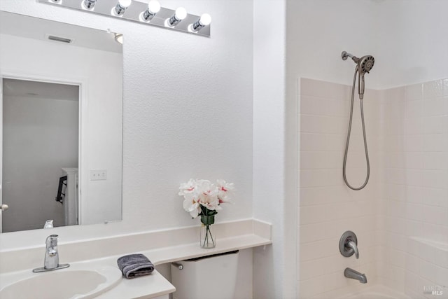 bathroom featuring shower / tub combination and vanity