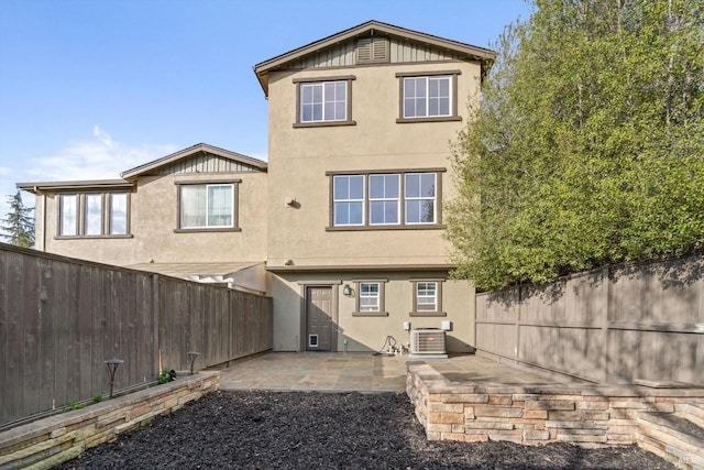 rear view of house with a patio and central air condition unit