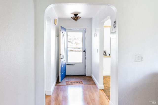 doorway with hardwood / wood-style flooring