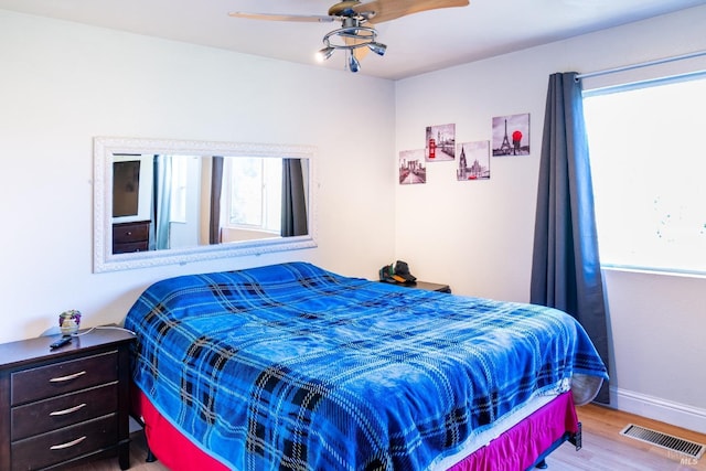 bedroom with hardwood / wood-style floors and ceiling fan