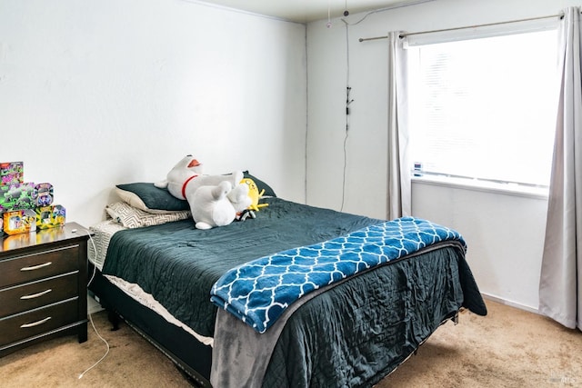 carpeted bedroom with multiple windows