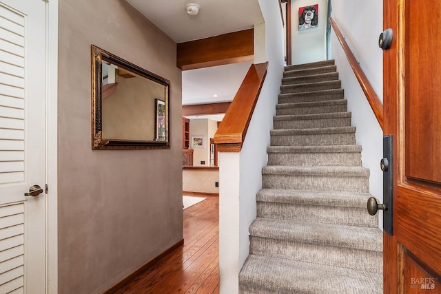 stairway featuring wood-type flooring